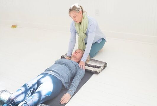Image - Amy Lloyd assisting a woman with yoga - Amy Lloyd Wellness & Yoga, Roswell, GA
